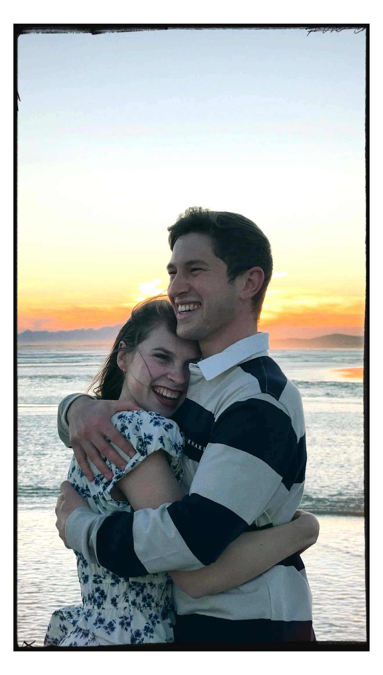 A couple embracing on the beach at golden hour