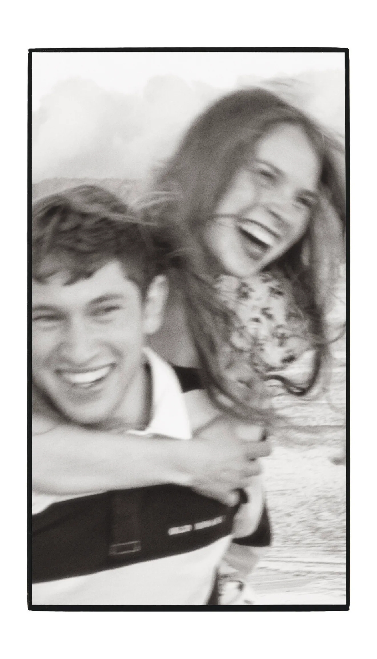A black and white portrait of a laughing couple